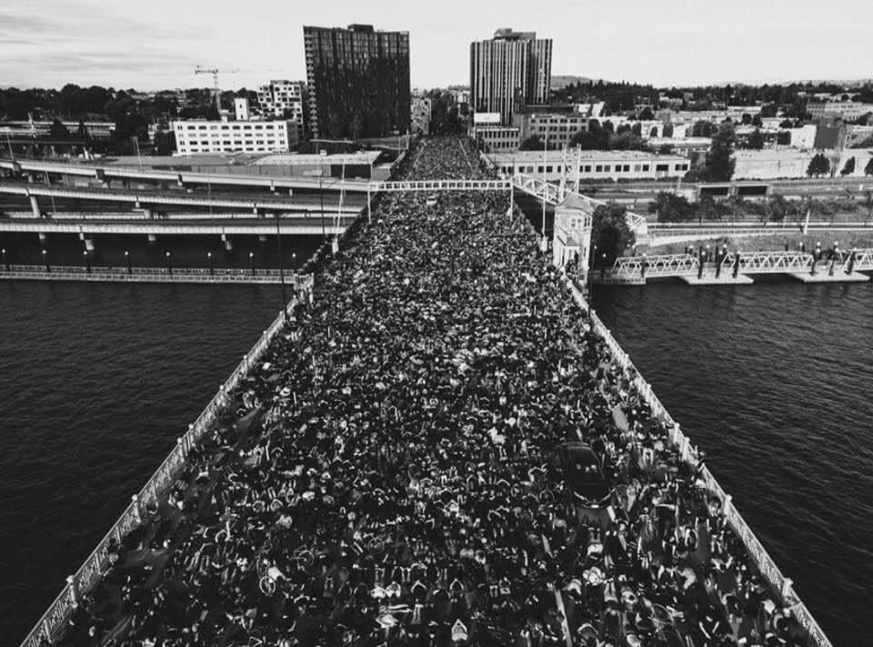 Portland's Burnside Bridge, thousands of protestors kneeling in protest of lethal anti-Black racism. 